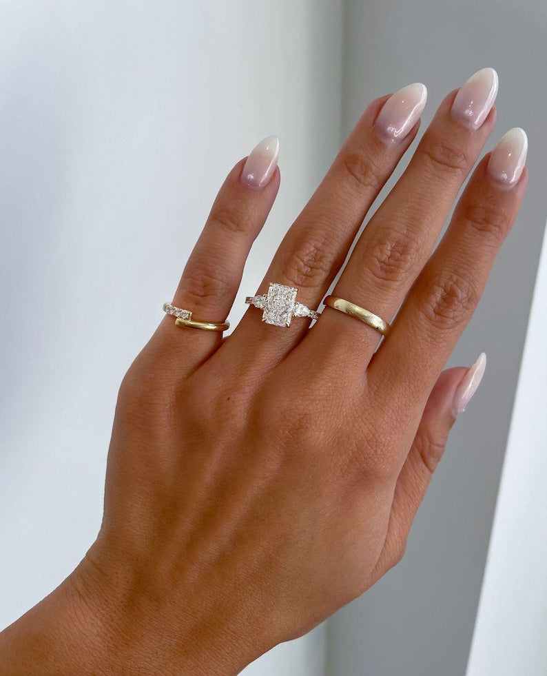 Radiant cut side-stone engagement ring