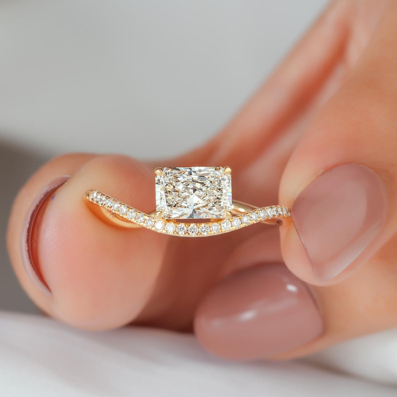 Emerald cut diamond orientation considerations for an east-west ring