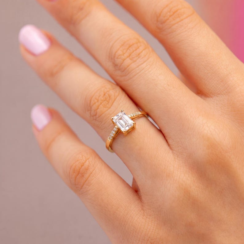 Emerald cut engagement ring with trapezoid side stones