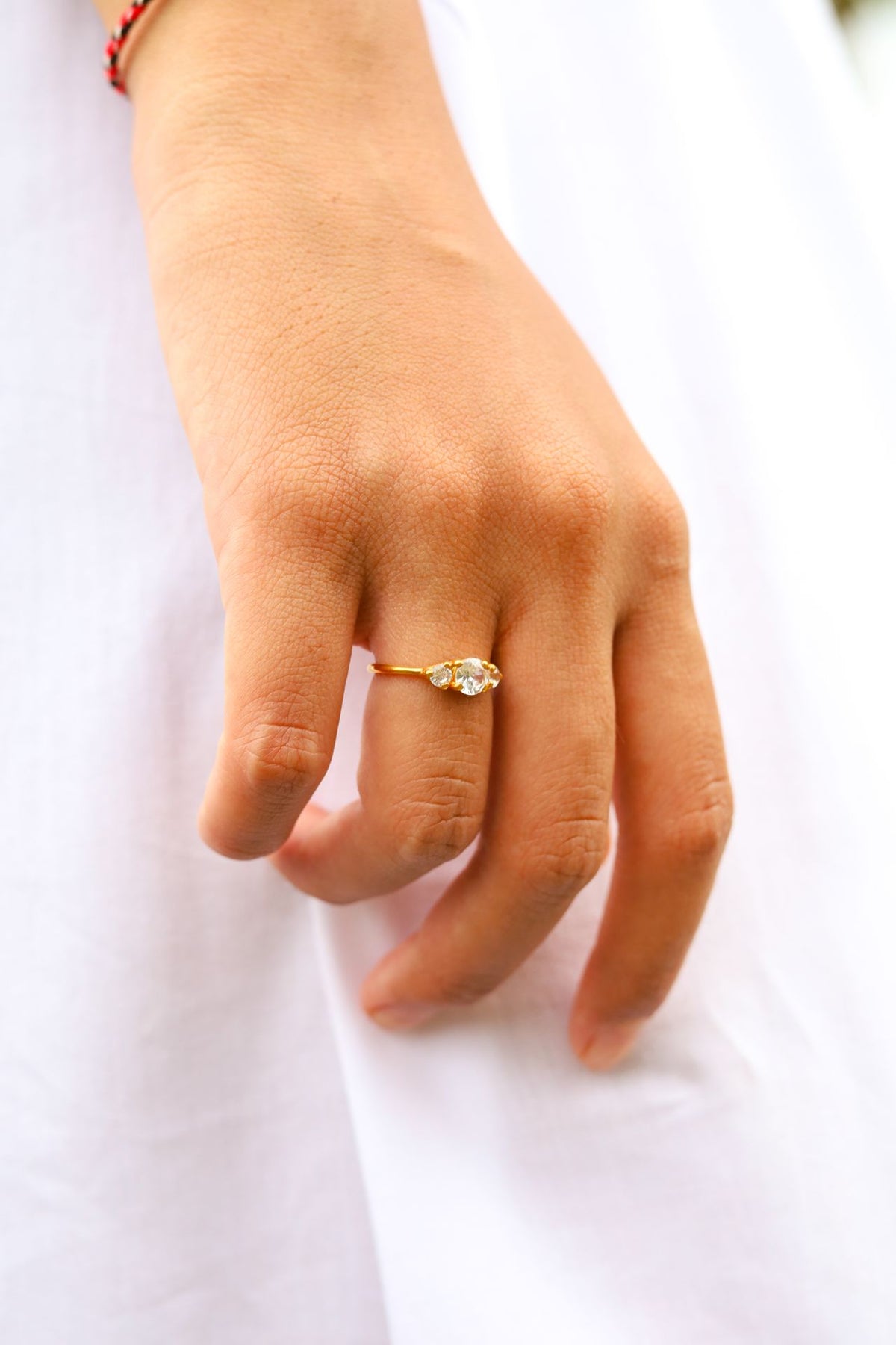 Trilogy engagement ring on hand
